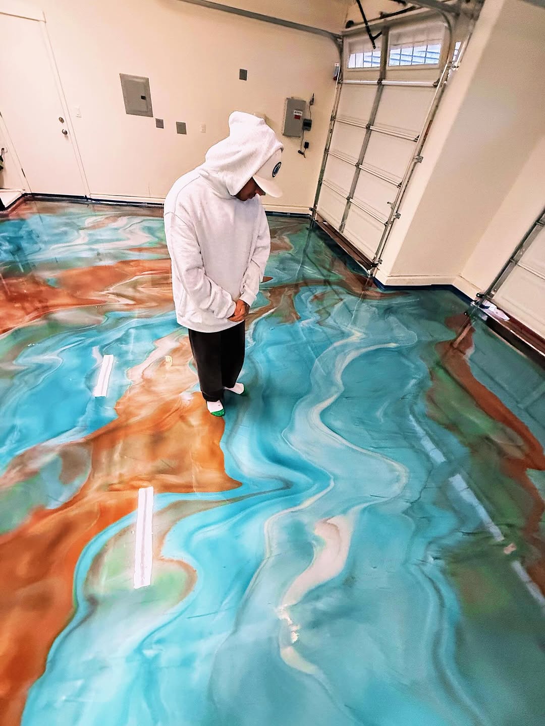 Metallic epoxy garage floor with silver and charcoal swirls