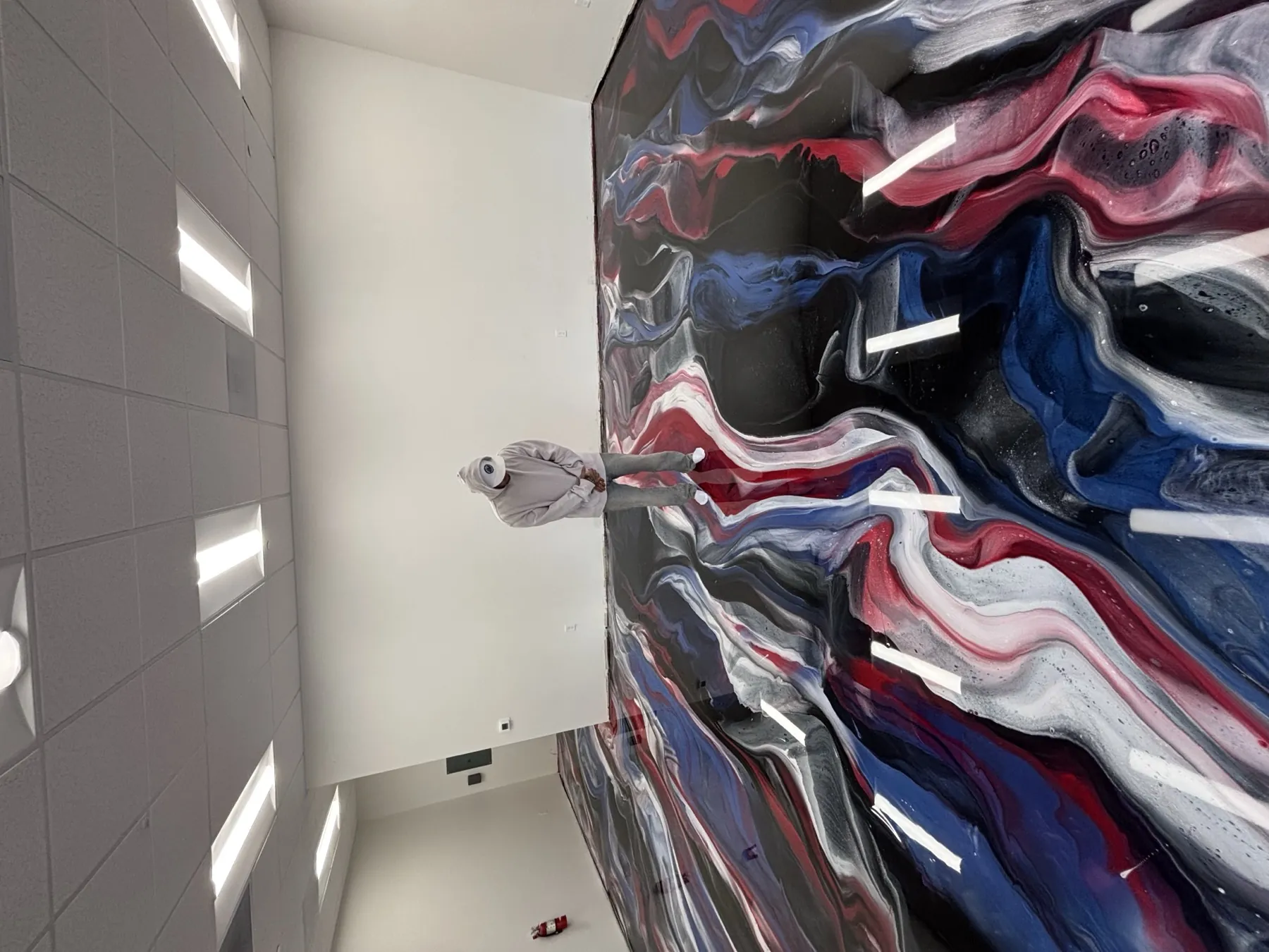 Red, navy and white metallic epoxy floor rippling across an open office suite